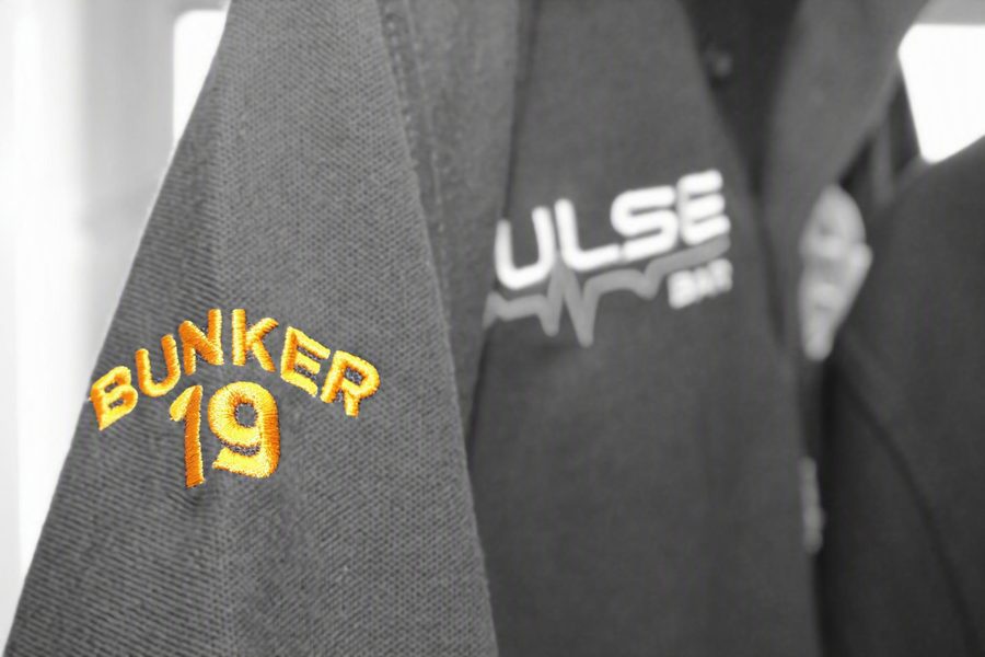 Bunker 19 and Pulse Bar embroidered logos on grey polo shirts from SVP Southend Embroidery