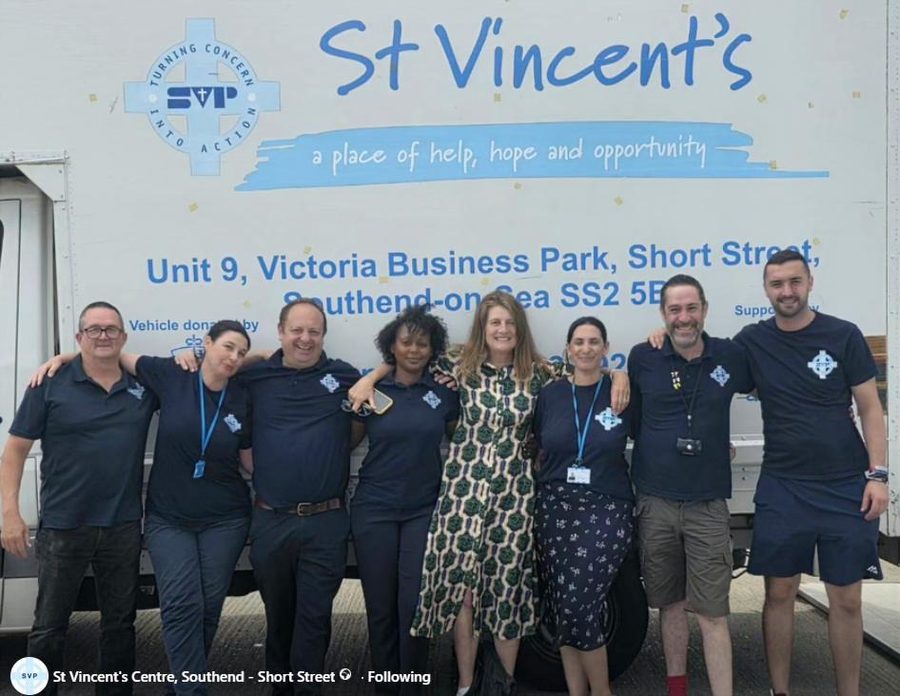 SVP Southend team standing outside St Vincent's Centre wearing navy embroidered polo shirts with SVP logos